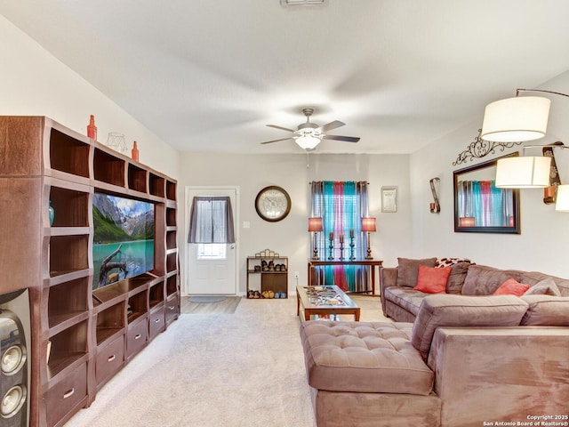 living room with ceiling fan and light colored carpet