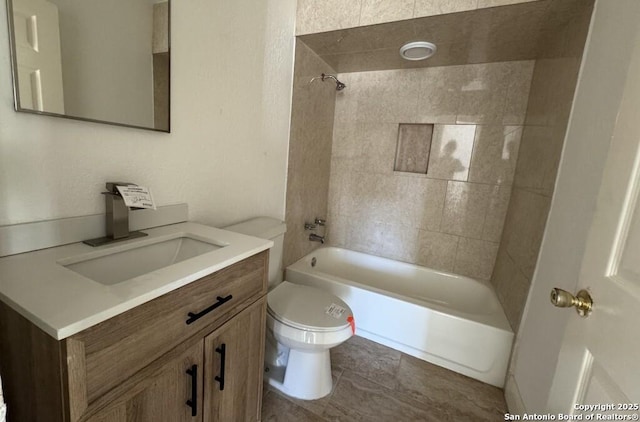 full bathroom featuring vanity, toilet, and tiled shower / bath combo