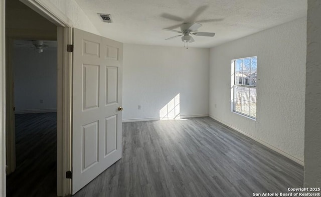 interior space with hardwood / wood-style flooring, ceiling fan, and a textured ceiling