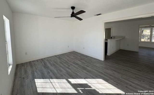 empty room featuring dark hardwood / wood-style floors and ceiling fan