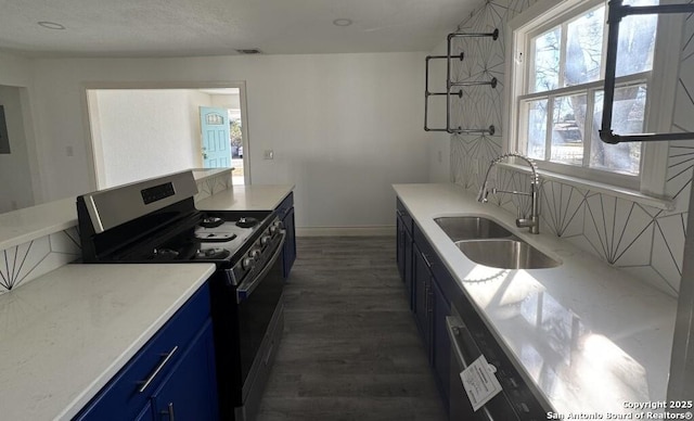 kitchen featuring blue cabinets, sink, dark wood-type flooring, and range