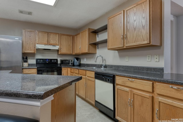 kitchen featuring appliances with stainless steel finishes, sink, a textured ceiling, and light brown cabinets