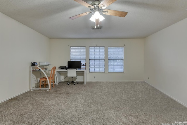 unfurnished office with ceiling fan, carpet floors, and a textured ceiling