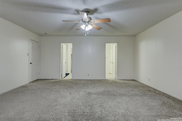 spare room featuring ceiling fan, light carpet, and a textured ceiling