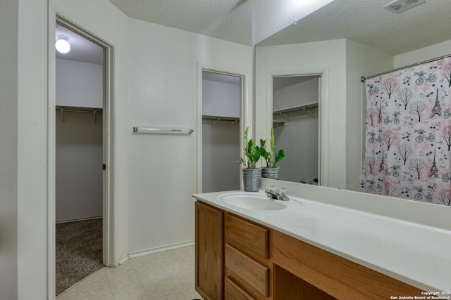 bathroom with vanity and a textured ceiling