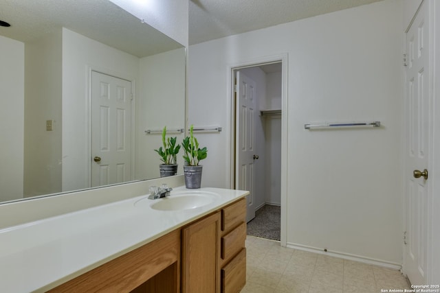 bathroom with vanity and a textured ceiling