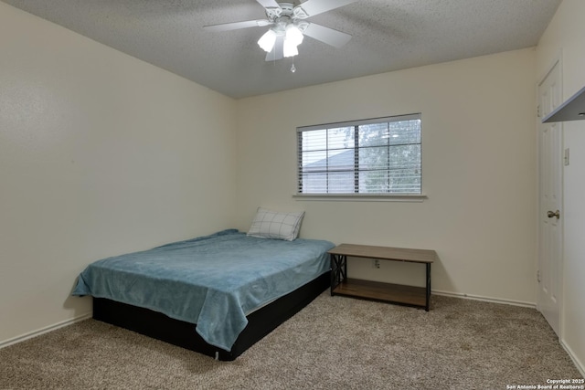 bedroom featuring ceiling fan, a textured ceiling, and carpet