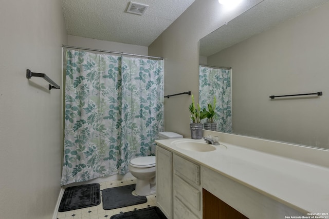 bathroom featuring vanity, a textured ceiling, toilet, and walk in shower