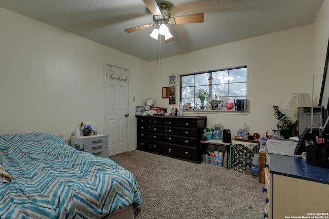 bedroom with ceiling fan, carpet flooring, and a textured ceiling