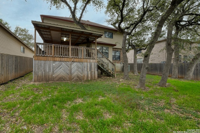 rear view of property featuring a yard