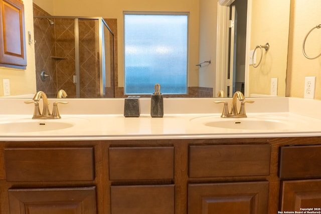 bathroom featuring vanity and a shower with shower door