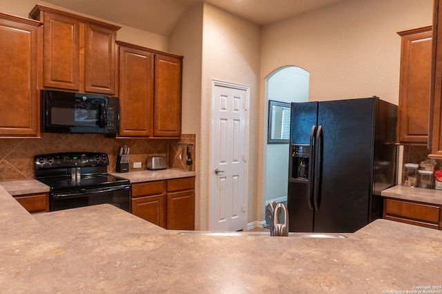 kitchen with tasteful backsplash and black appliances