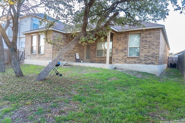 back of property featuring cooling unit, a yard, and a patio