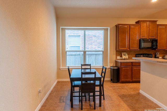 kitchen featuring tasteful backsplash and light tile patterned floors