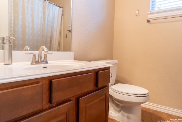 bathroom featuring vanity, tile patterned floors, and toilet