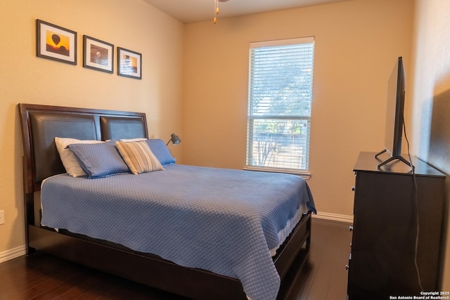 bedroom with dark wood-type flooring