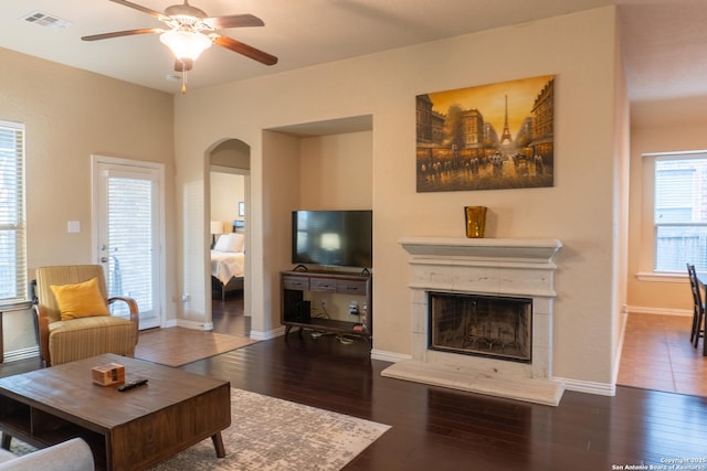 living room with ceiling fan and dark hardwood / wood-style floors