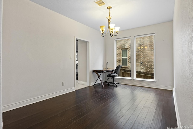 unfurnished office with dark hardwood / wood-style flooring and a notable chandelier