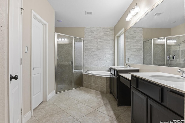 bathroom with tile patterned flooring, shower with separate bathtub, and vanity