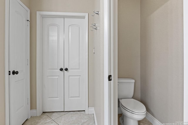 bathroom featuring tile patterned floors and toilet