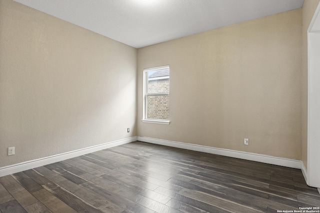 unfurnished room with dark hardwood / wood-style flooring