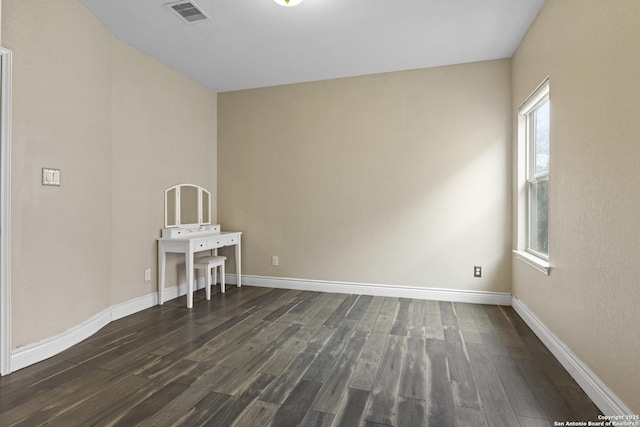 unfurnished room featuring dark hardwood / wood-style floors