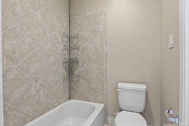 bathroom featuring toilet and tiled shower / bath combo