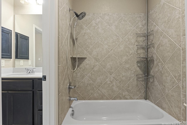 bathroom with vanity and tiled shower / bath