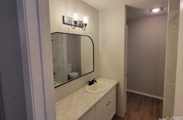 bathroom featuring hardwood / wood-style flooring, vanity, and toilet