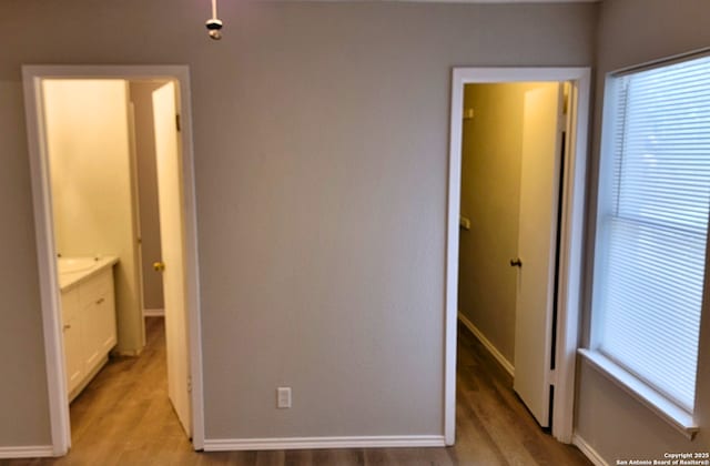 unfurnished bedroom with multiple windows and light wood-type flooring