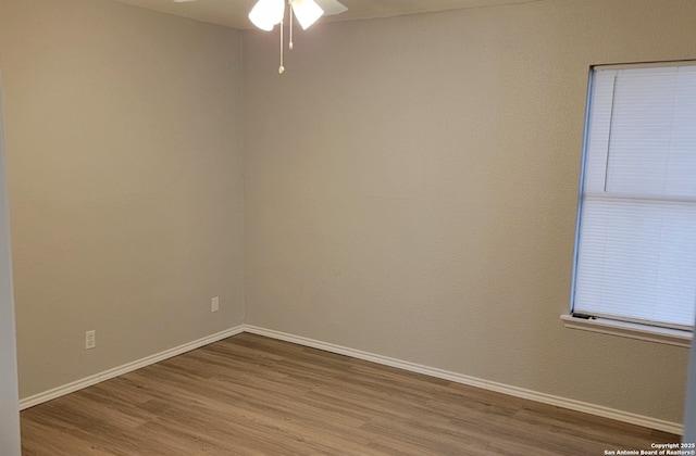 empty room with ceiling fan and wood-type flooring