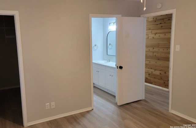 hall with sink and light hardwood / wood-style flooring