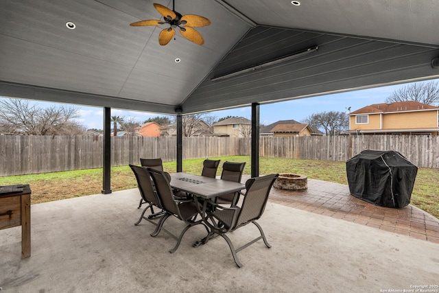 view of patio with ceiling fan, an outdoor fire pit, a fenced backyard, and a grill