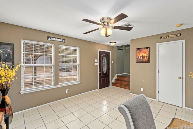 foyer entrance with light tile patterned floors, ceiling fan, stairs, and visible vents