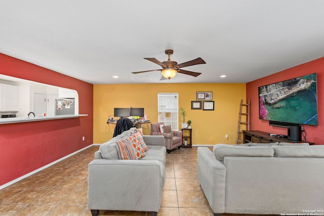 living area with a ceiling fan, recessed lighting, baseboards, and light tile patterned floors