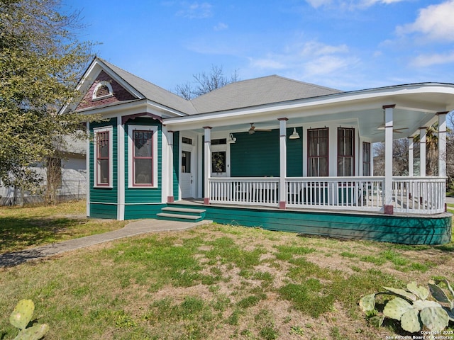 view of front of property with covered porch and a front lawn