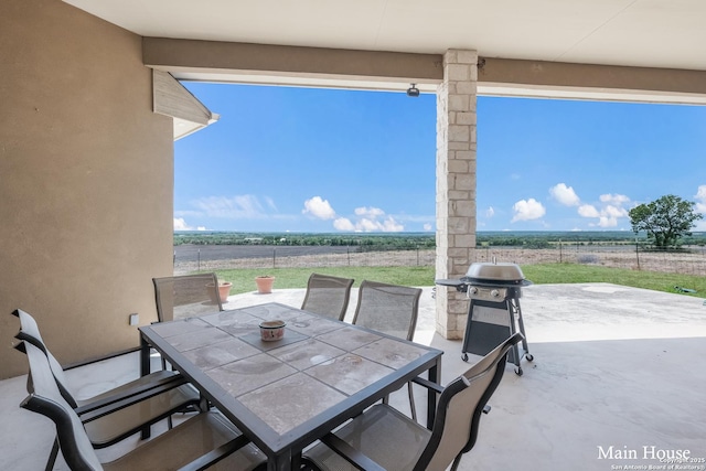 view of patio with a grill and a rural view