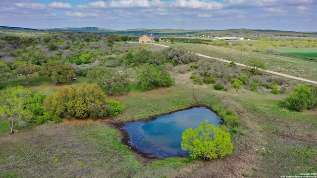 birds eye view of property featuring a water view and a rural view