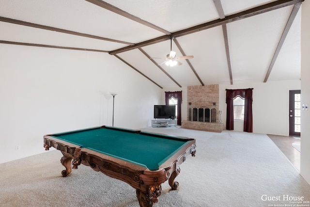 recreation room with billiards, ceiling fan, carpet, lofted ceiling with beams, and a brick fireplace