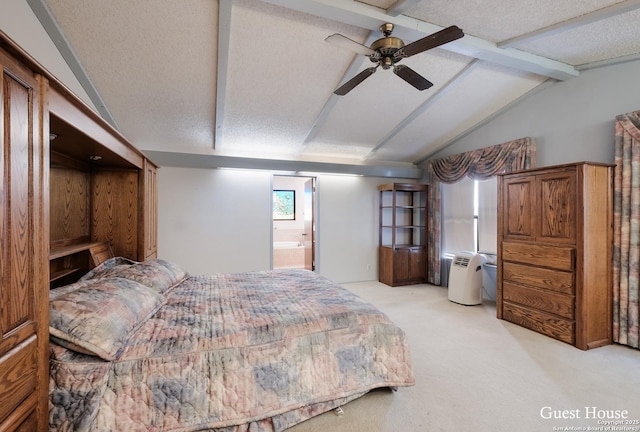 carpeted bedroom with lofted ceiling with beams, a textured ceiling, and ensuite bathroom