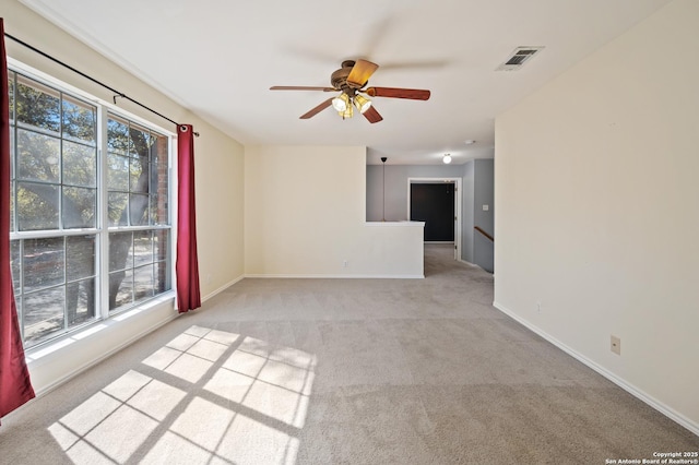 unfurnished room featuring light carpet and ceiling fan