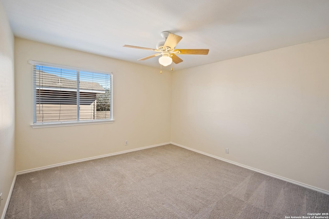 carpeted spare room with ceiling fan