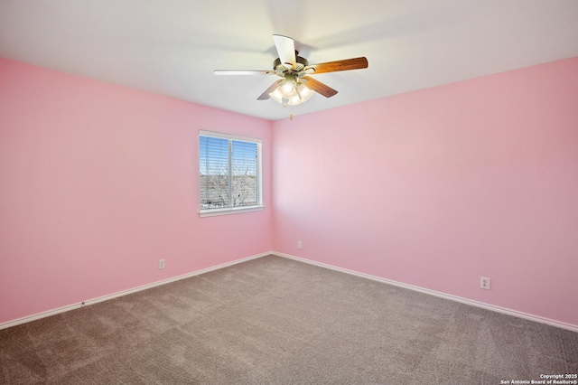 carpeted spare room featuring ceiling fan