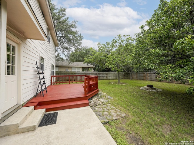 view of yard with a wooden deck and an outdoor fire pit