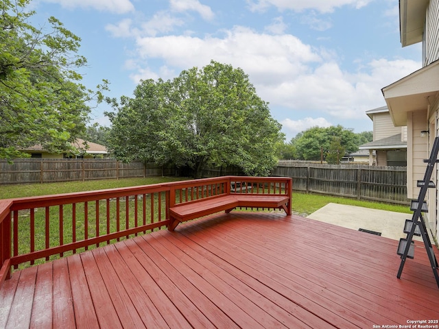 deck featuring a patio and a yard