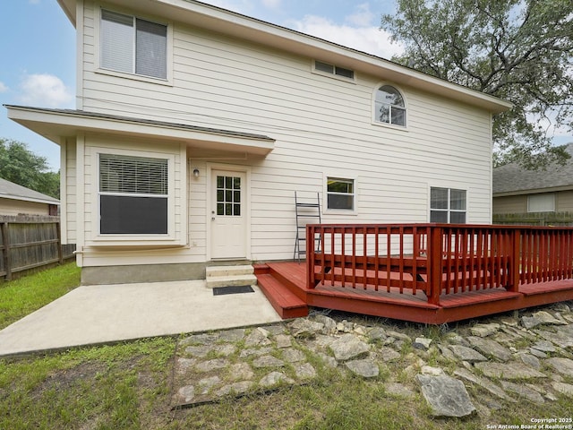 rear view of property featuring a deck and a patio area