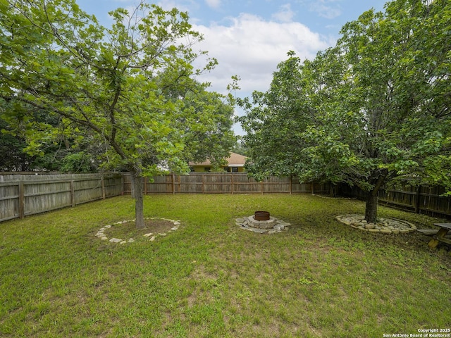 view of yard featuring an outdoor fire pit