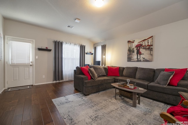 living room with vaulted ceiling and dark hardwood / wood-style floors