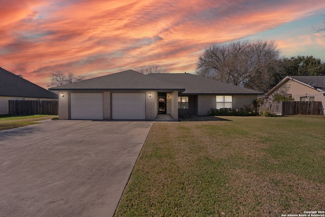 view of front of home featuring a garage and a lawn