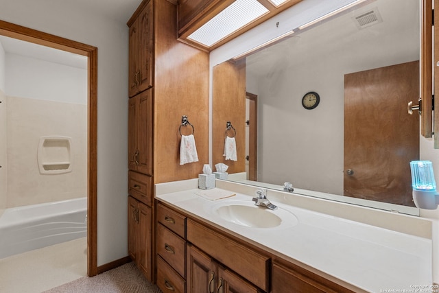 bathroom featuring vanity and a skylight